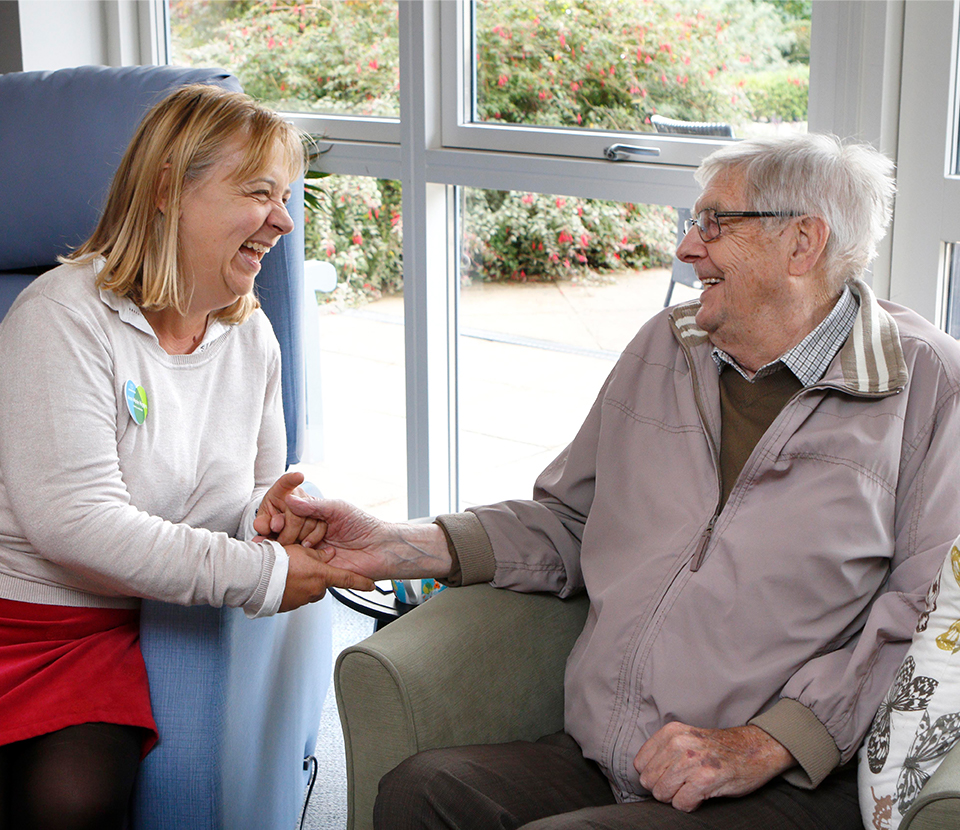 Longfield volunteer laughing with male patient