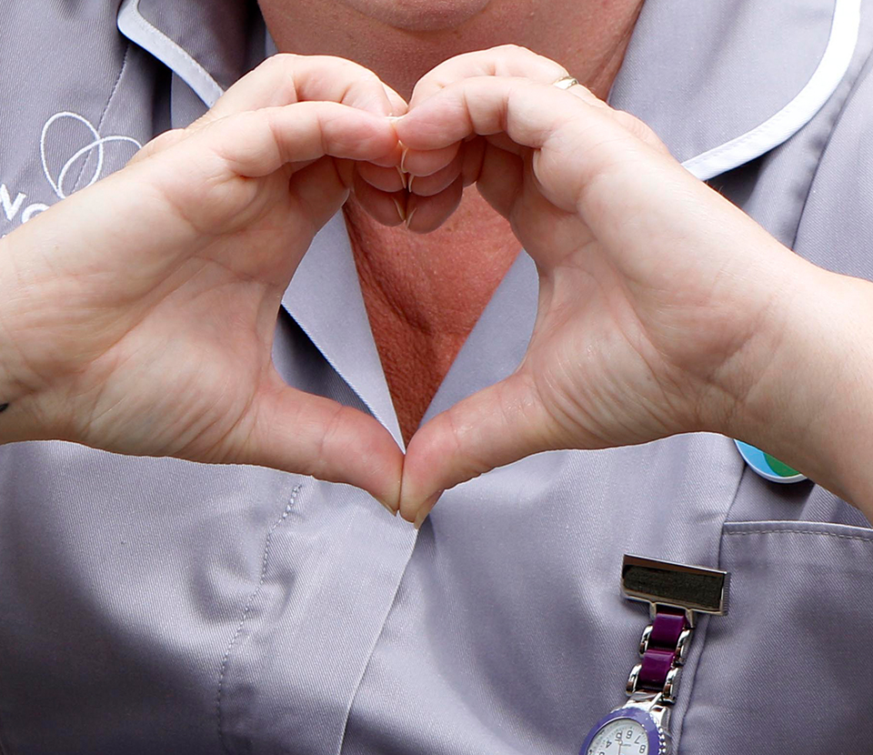 Nurse forming a heart with her hands